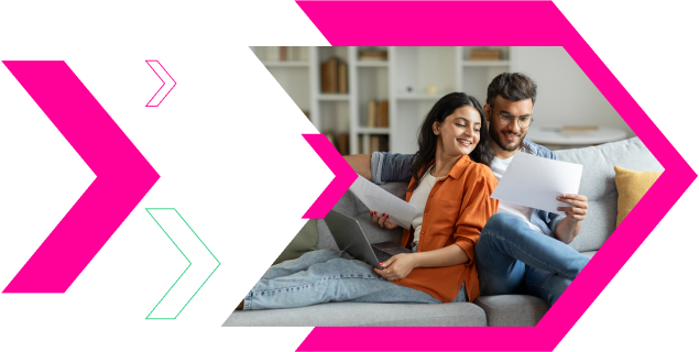 Couple sitting on a couch reviewing documents